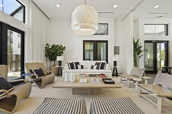 a living room filled with furniture and a large table